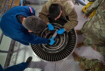 Propulsion technicians work on engine