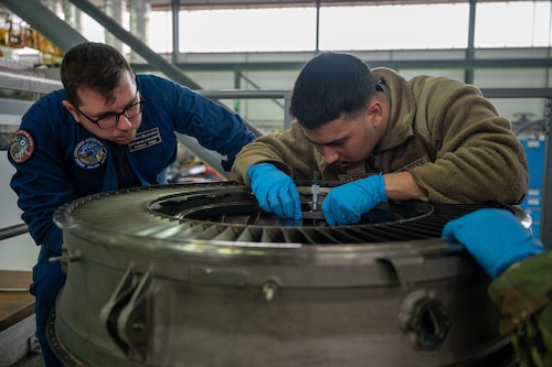 Propulsion technicians work on engine