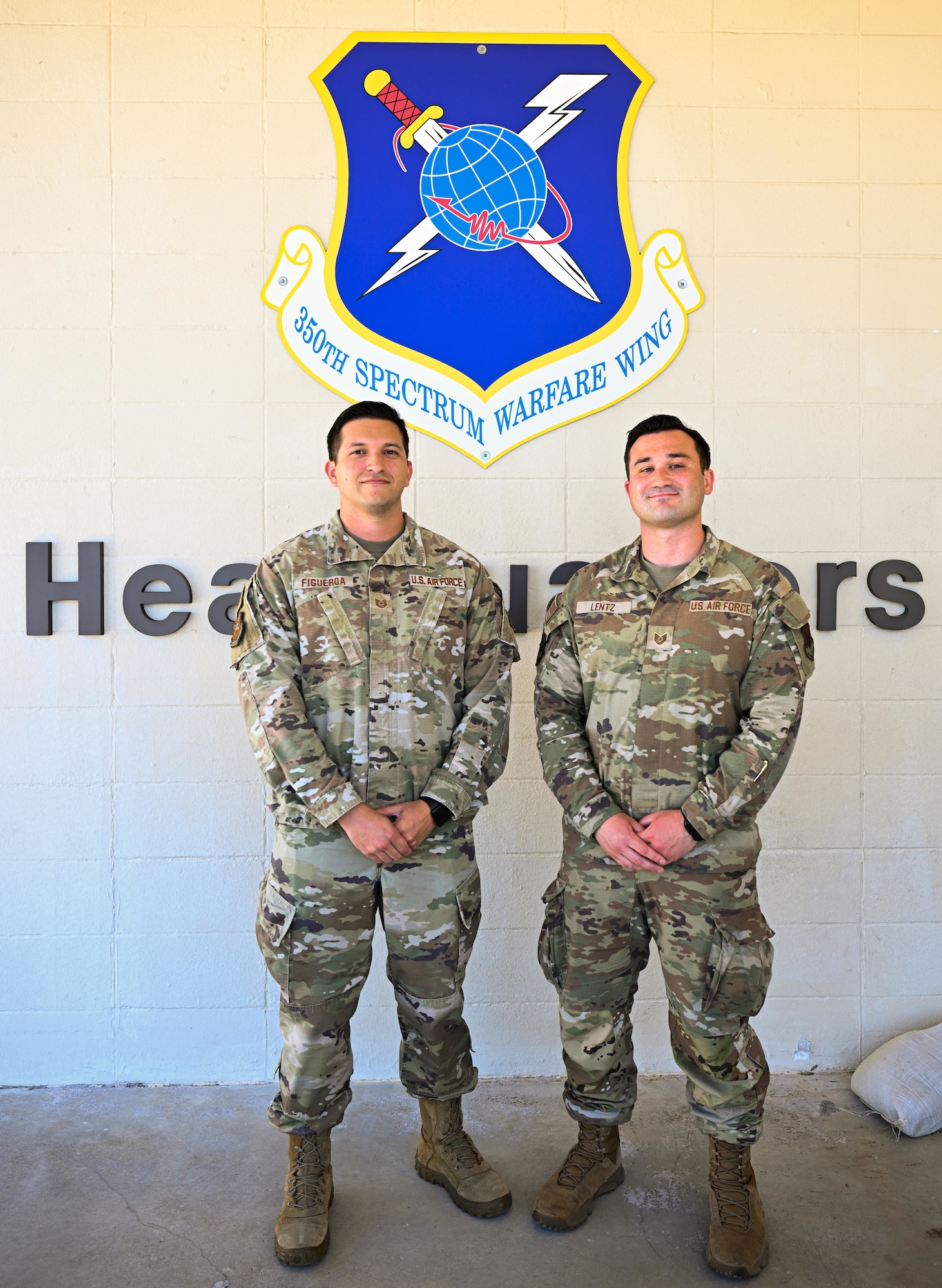 U.S. Air Force Tech. Sgt. Carlos Figueroa, 350th Spectrum Warfare Wing IT support section chief, left, and U.S. Air Force Tech. Sgt. Stephen Lentz, 87th Electronic Warfare Squadron Combat Shield avionics electronic warfare craftsman, right, stand side-by-side for a photo at Eglin Air Force Base, Florida, March 26, 2025. Figueroa and Lentz were both selected for the U.S. Air Force Officer Training School from the 350th Spectrum Warfare Wing. (U.S. Air Force photo by Senior Airman Anna Smith)