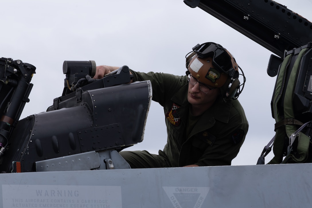 U.S. Marine Corps Sgt. Garrett Maurer, a fixed-wing aircraft mechanic with Marine Fighter Attack Squadron (VMFA) 312, 2nd Marine Aircraft Wing, inspects an F/A-18D Hornet aircraft at the Panamá Pacífico Airfield, Panama, April 5, 2025. VMFA-312 continues day to day operations during a short-term visit in support of an expanded strategic security partnership with Panama. (U.S. Marine Corps photo by Lance Cpl. Van Hoang)