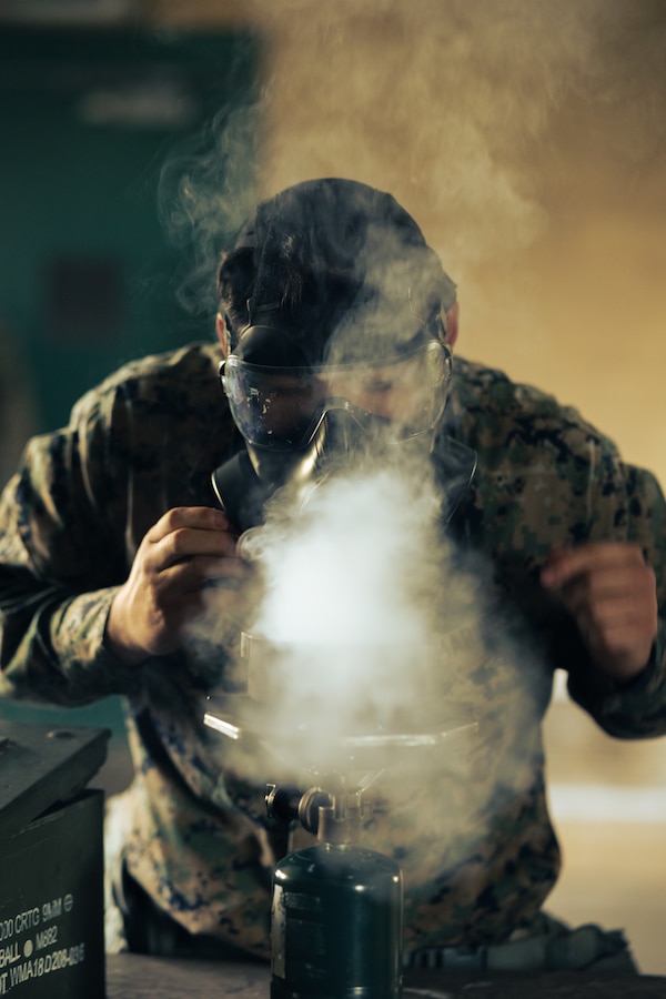 A U.S. Marine Corps chemical, biological, radiological, nuclear (CBRN) specialist assigned to 1st Combat Engineer Battalion, 1st Marine Division, disperses chlorobenzalmalononitrile, or CS gas, during CBRN training at Marine Corps Base Camp Pendleton, California, April 3, 2025. The CBRN training served to increase Marines’ confidence in their equipment and maintain proficiency in operating in a CBRN-contaminated environment. The M-50 field protective mask is designed to provide 24 hours of continuous head-eye-respiration protection against chemical agents, biological agents, radiological particulates, and toxic industrial chemicals. (U.S. Marine Corps photo by Gunnery Sgt. Manuel A. Serrano)