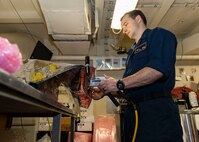 Aviation Electronics Technician 2nd Class Kaleb Smith, assigned to aviation intermediate maintenance department aboard the world’s largest aircraft carrier, USS Gerald R. Ford (CVN 78), seals electrostatic shield wrapping in the component control section, April 5, 2025.