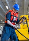 Boatswain’s Mate Seaman Apprentice Trey Avery, assigned to deck department aboard the world’s largest aircraft carrier, USS Gerald R. Ford (CVN 78), lays down a line in the hanger bay during a replenishment-at-sea (RAS), April 4, 2025.