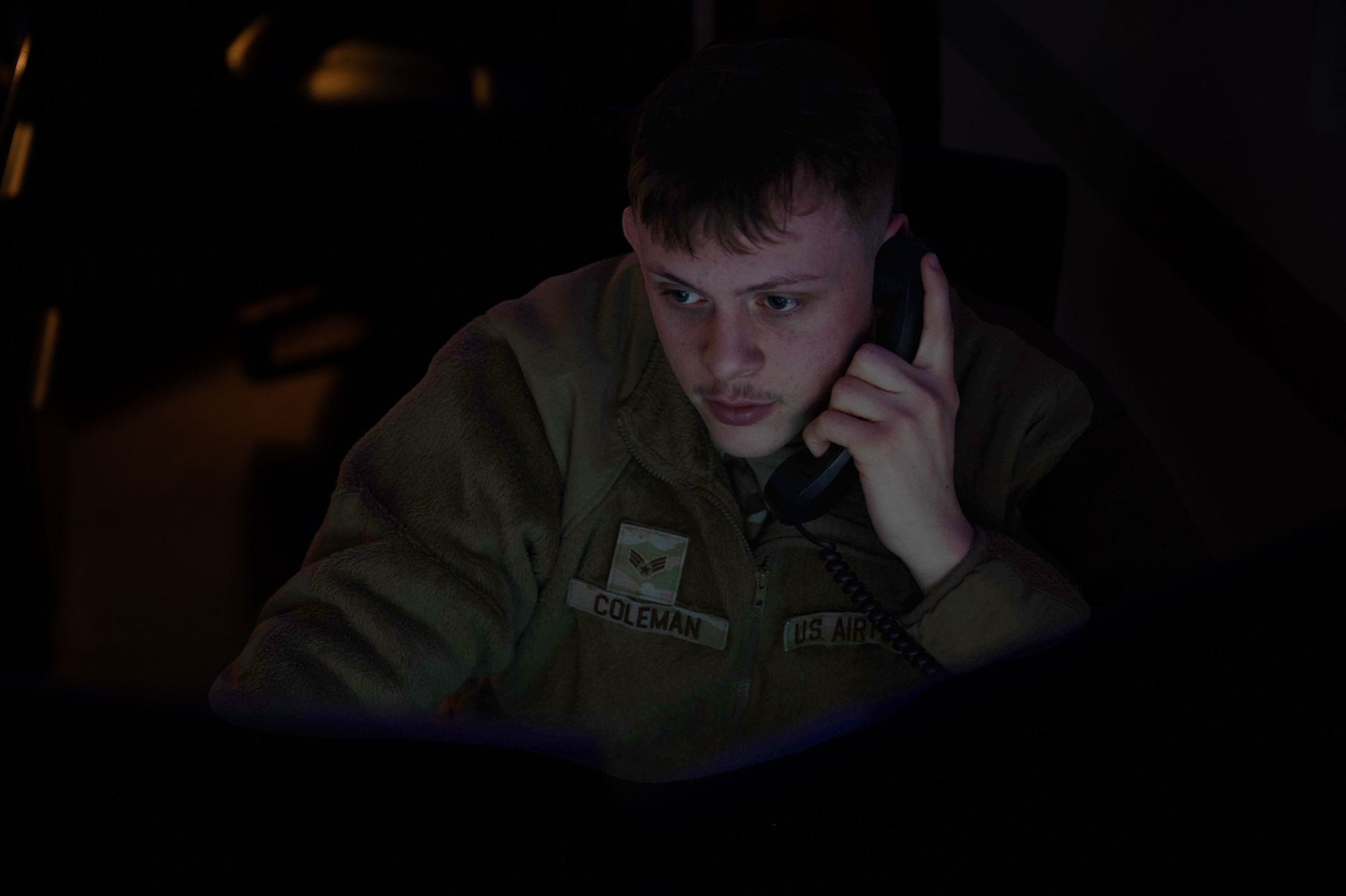 An Airman speaks on a phone.