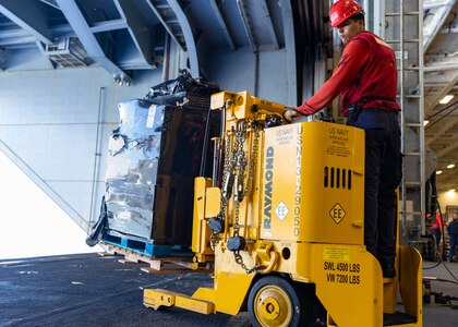 Aviation Ordnanceman 3rd Class Luis Vanegas, assigned to weapons department aboard the world’s largest aircraft carrier, USS Gerald R. Ford (CVN 78), operates a forklift in the hangar bay during a replenishment-at-sea (RAS), April 4, 2025.