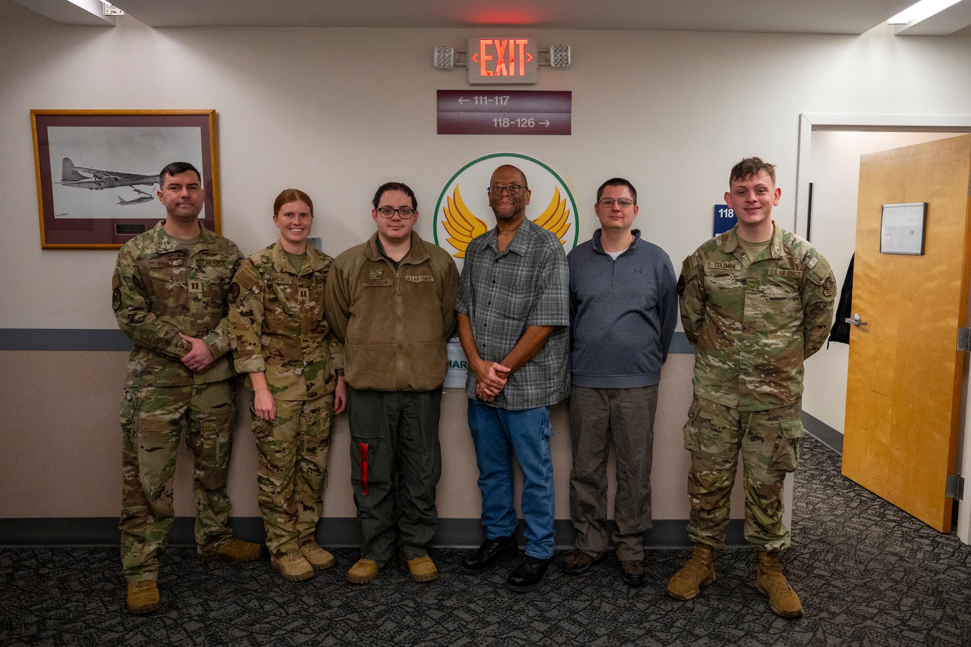 Members of an office pose for a photo.