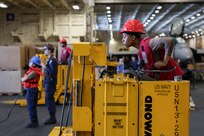 Aviation Ordnanceman 3rd Class Brandi Terry, assigned to weapons department aboard the world’s largest aircraft carrier, USS Gerald R. Ford (CVN 78), operates a forklift in the hangar bay, April 4, 2025.