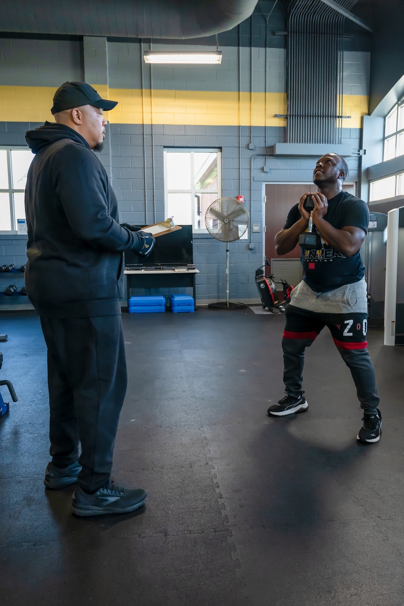 Terrence Oglesby, 169th Force Support Squadron fitness trainer for the 169th Fighter Wing, works with U.S. Air Force Senior Airman Leonard Howell, 169th Maintenance Squadron aircraft electrical and environmental systems specialist