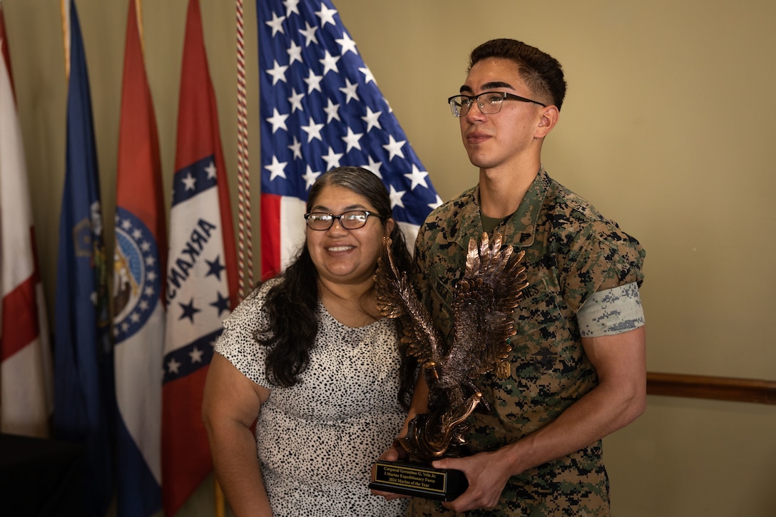 U.S. Marine Corps Cpl. Geronimo Vela Jr., an intelligence specialist with the 13th Marine Expeditionary Unit, I Marine Expeditionary Force, poses for a portrait with his mother after an award ceremony at Marine Corps Base Camp Pendleton, California, March 31, 2025.
