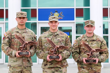 Sgt. Daniel Miller, center, of the 166th Regiment – Regional Training Institute won Noncommissioned Officer of the Year; Spc. Robert Ruiz, left, of the 28th Expeditionary Combat Aviation Brigade won Soldier of the Year; and Sgt. 1st Class Tyler Landis, right, of the Pennsylvania Army National Guard Recruiting and Retention Battalion won the Command Sgt. Maj. Jay H. Fields NCO Leadership Award at the Pennsylvania Army National Guard’s state-level best warrior competition at Fort Indiantown Gap, Pa. April 3–6, 2025. (U.S. Army National Guard photo by )