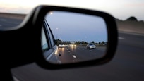 Picture of a rear-view mirror in traffic.