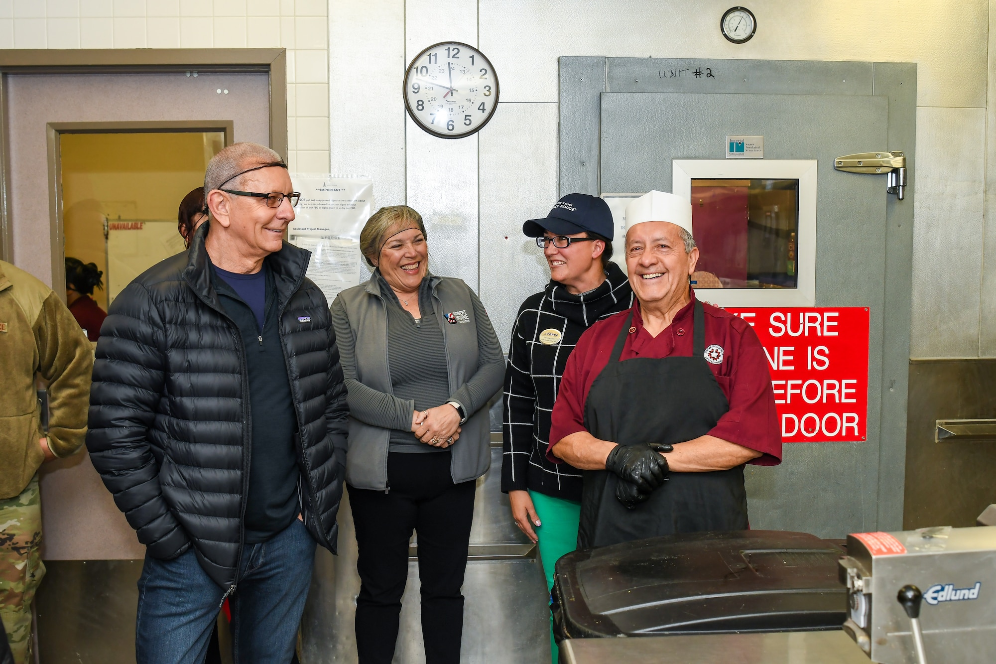 Celebrity chef Robert Irvine talks with 50th Force Support Squadron base dining facility staff members during a kitchen tour at Schriever Space Force Base, Colorado, April 3, 2025. During his visit to Schriever SFB, Irvine and the Robert Irvine Foundation toured the Child Development Center kitchen and The Dish to engage with Guardians, Airmen, and staff. (U.S. Space Force photo by Dalton Prejeant)