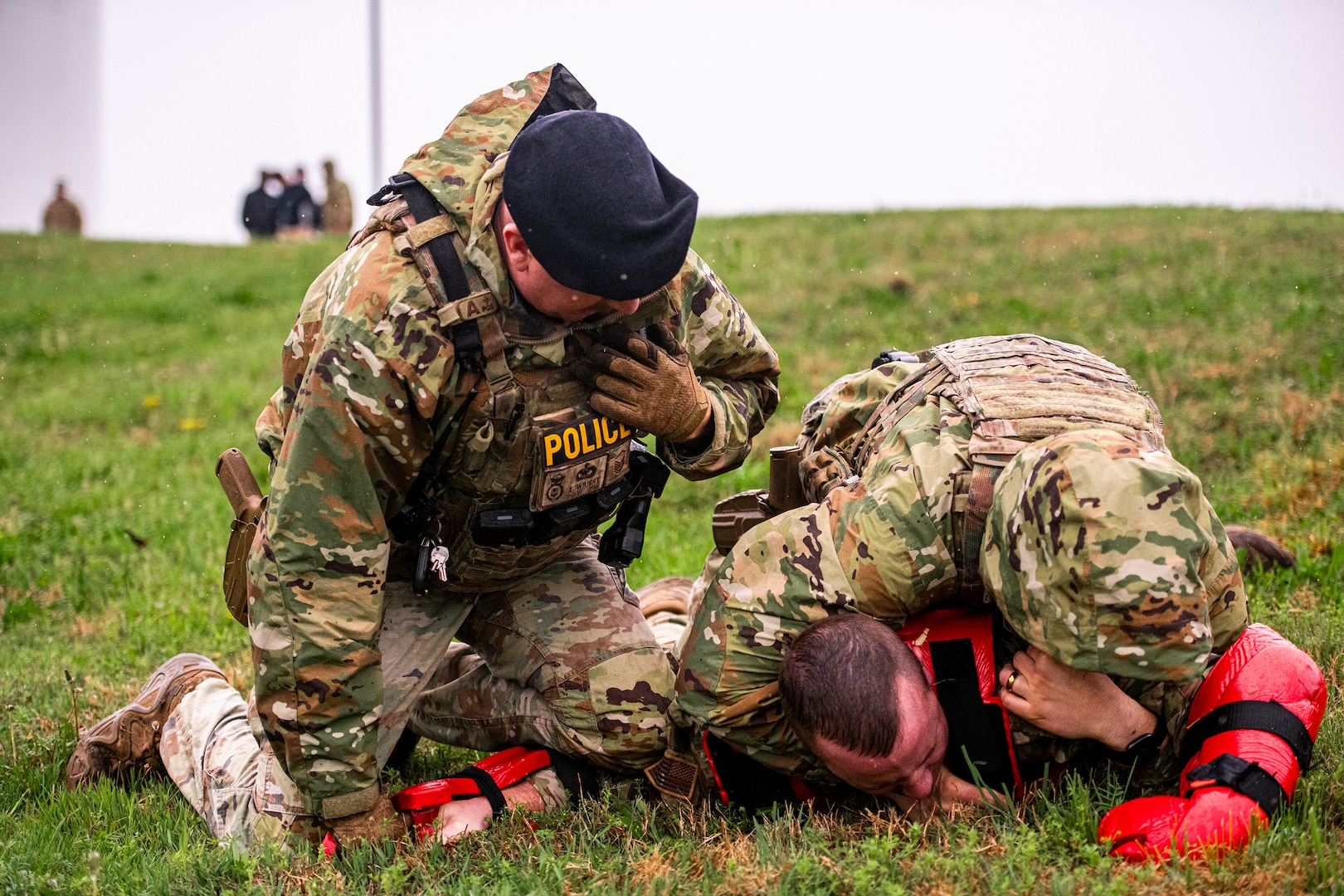 U.S. Air National Guard Master Sgt. Bryan Wright from the 134th Security Forces Squadron radios dispatch while Tech. Sgt. Ryan Sharp restrains a suspect during a perimeter breach exercise on McGhee Tyson Air National Guard Base, Tennessee, April 6, 2025.