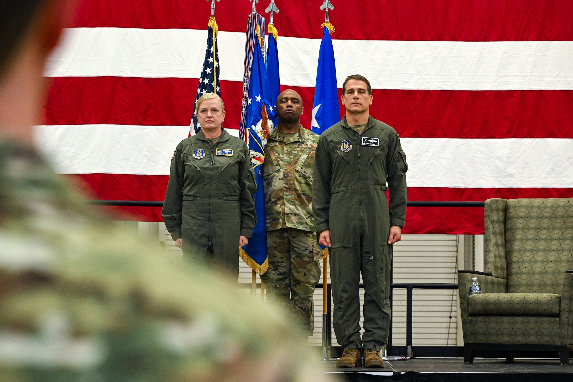 Maj. Gen. Melissa Coburn, 22nd Air Force commander, Chief Master Sgt. Howard Dixon, 910th Airlift Wing command chief, and Col. Chris Sedlacek, 910th AW commander, stand at the position of attention during an assumption of command ceremony at Youngstown Air Reserve Station, Ohio, April 6, 2025.