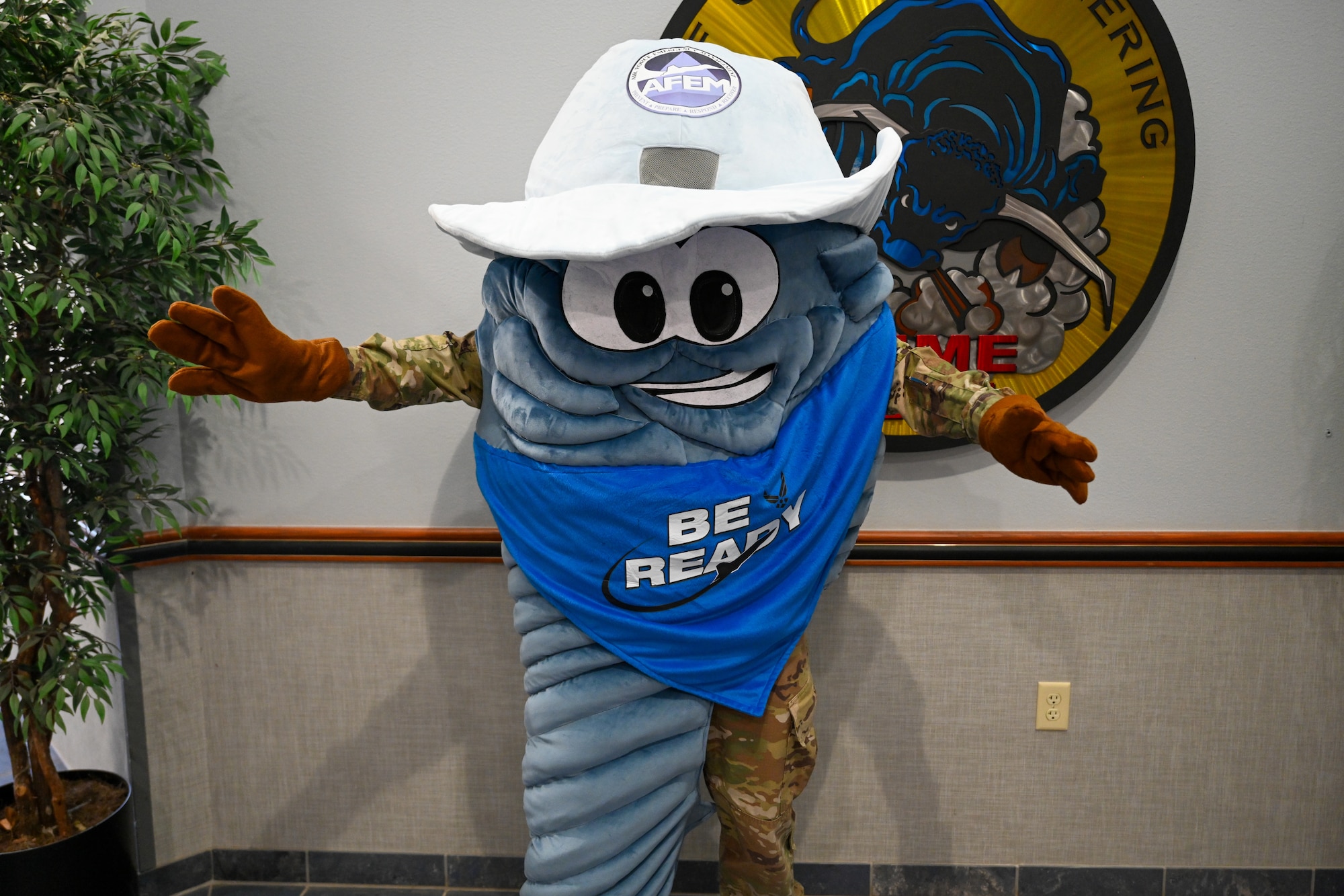 Twisty the Tornado, 97th Civil Engineer Squadron (CES) emergency management mascot, stands ready in front of the 97th CES logo to inform personnel about the importance of readiness. Twisty frequently appears at severe weather briefings held by the 97th CES to help inform the public on how to stay safe. (U.S. Air Force photo by Airman 1st Class Nathan Langston)