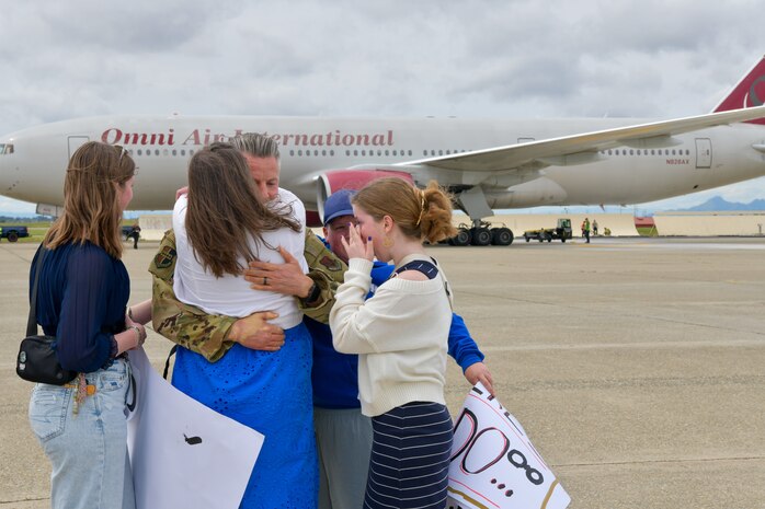 U.S. Air Force Col. Keagan L. McLeese, 9th Reconnaissance Wing base commander, embraces family at Beale Air Force Base, California, April 7, 2025