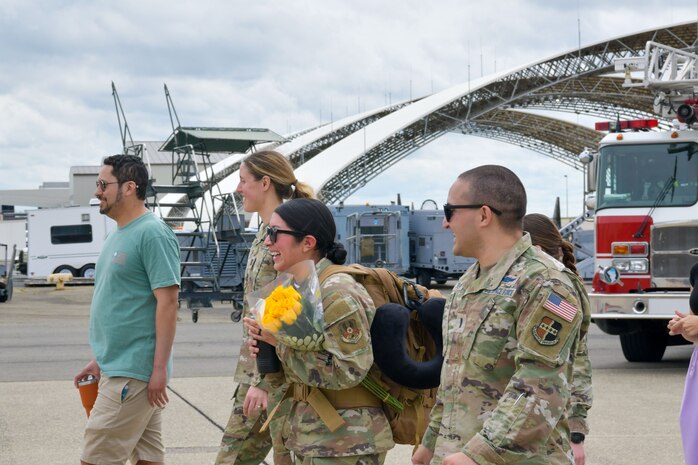 U.S. Air Force Airmen assigned to the 9th Reconnaissance Wing are greeted by family members and Beale personnel as they return from a six-month deployment at Beale Air Force Base, California, April 7, 2025.