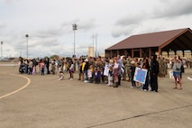 U.S. Air Force Airmen, families and friends await the arrival of deployed Airmen at Beale Air Force Base, California, April 7, 2025