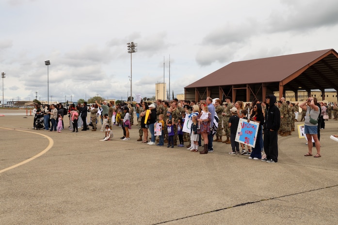 U.S. Air Force Airmen, families and friends await the arrival of deployed Airmen at Beale Air Force Base, California, April 7, 2025