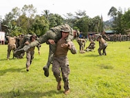 U.S. Marines and Sailors with Marine Rotational Force — Darwin 25.3 and Armed Forces of the Philippines service members practice fireman carries during tactical field care training as part of Marine Exercise 2025 near Cotabato City, Mindanao, Philippines, April 1, 2025.
