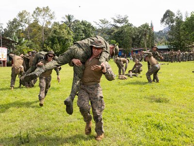 U.S. Marines and Sailors with Marine Rotational Force — Darwin 25.3 and Armed Forces of the Philippines service members practice fireman carries during tactical field care training as part of Marine Exercise 2025 near Cotabato City, Mindanao, Philippines, April 1, 2025.