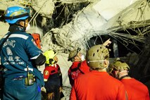 U.S. Indo-Pacific Command servicemembers work alongside Thai military and first responders near the collapsed State Audit Office building in Bangkok, which fell after a 7.7 magnitude earthquake affected Thailand and its neighboring countries on March 28, 2025.
