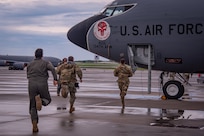U.S. Air National Guard Airmen assigned to the 134th Operations Group run toward a KC-135R Stratotanker as part of an alert response during a Nuclear Operational Readiness Exercise at McGhee Tyson Air National Guard Base, Tennessee.