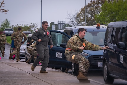 U.S. Air National Guard Airmen assigned to the 134th Operations Group run from their alert facility into vans as part of an alert response during a Nuclear Operational Readiness Exercise at McGhee Tyson Air National Guard Base, Tennessee.
