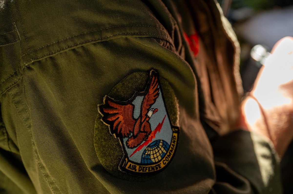 Donald Obreiter, 97th Maintenance Squadron director and lead flight engineer on the B-29 Superfortress ‘Doc’, bears the patch of the Air Defense Command, the original command Doc was under, in Wichita, Kansas, April 2, 2025. In 1987, Doc was found in the Mojave Desert and restoration began in 2000. (U.S. Air Force photo by Senior Airman Kari Degraffenreed)