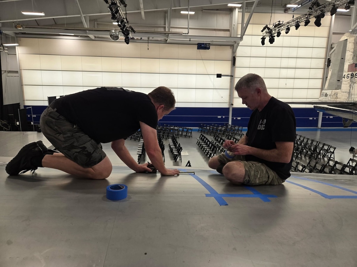 Donald Obreiter, 97th Maintenance Squadron director and lead flight engineer on the B-29 Superfortress ‘Doc’, and Jon Birket, ‘Doc’s Friends’ team member, put tape down before painting the original 1952 markings on Doc in Wichita, Kansas, March 30, 2025. Doc is the only B-29 to have all its original markings restored. (Courtesy photo)
