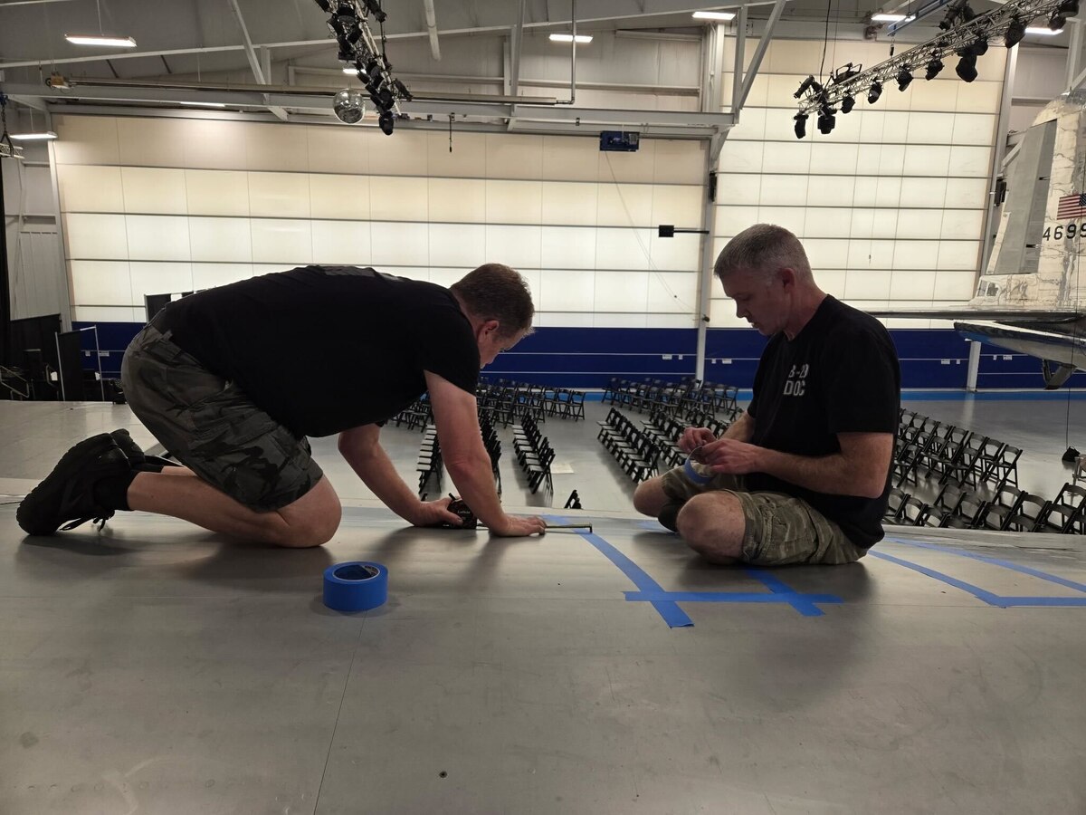 Donald Obreiter, 97th Maintenance Squadron director and lead flight engineer on the B-29 Superfortress ‘Doc’, and Jon Birket, ‘Doc’s Friends’ team member, put tape down before painting the original 1952 markings on Doc in Wichita, Kansas, March 30, 2025. Doc is the only B-29 to have all its original markings restored. (Courtesy photo)