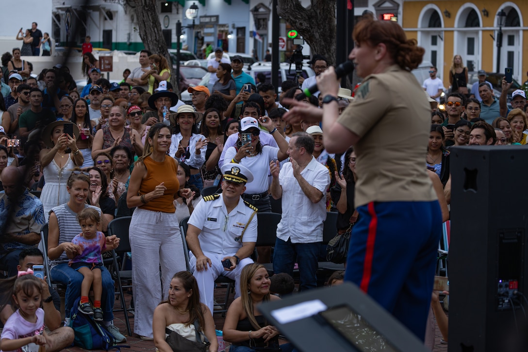 Panaminians and U.S. Navy Capt. Daniel Betancourt, senior U.S. defense official in Panama, attend a jazz and rock performance provided by the Marine Forces Reserve Band at Plaza Catedral in Casco Antiguo, Panama, April 6, 2025. The Marine Forces Reserve Band will be performing throughout the week in support of expanded partnership between the U.S. and Panama. (U.S. Marine Corps photo by Lance Cpl. Van Hoang)