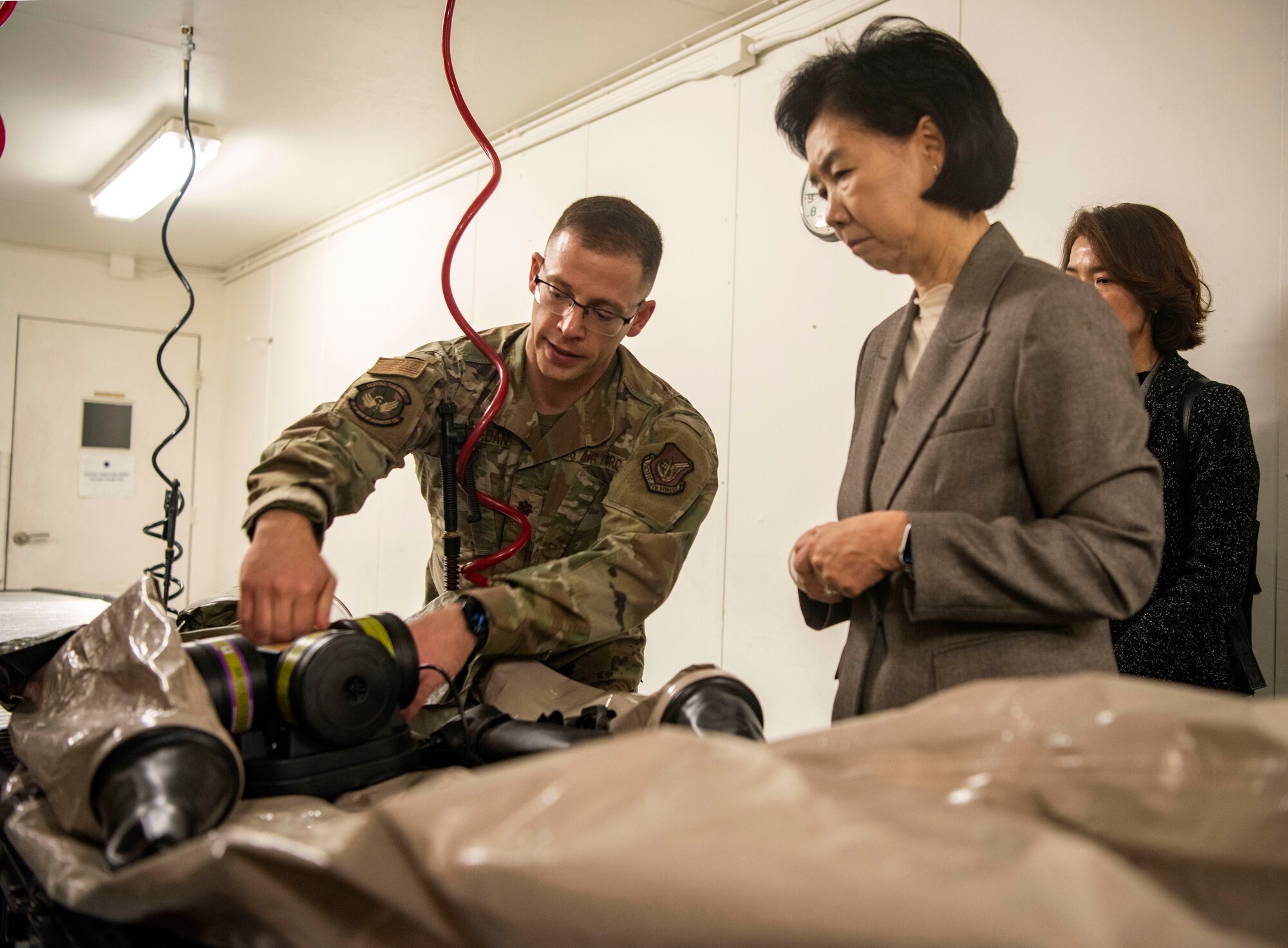 U.S. Air Force Maj. Romi Abouzedan, 51st Medical Group in-place patient decontamination team chief, left, briefs Dr. Young Mee Jee, Korea Disease Control Agency commissioner, about the 51st MDG’s patient decontamination capabilities at Osan Air Base, Republic of Korea, April 3, 2025.