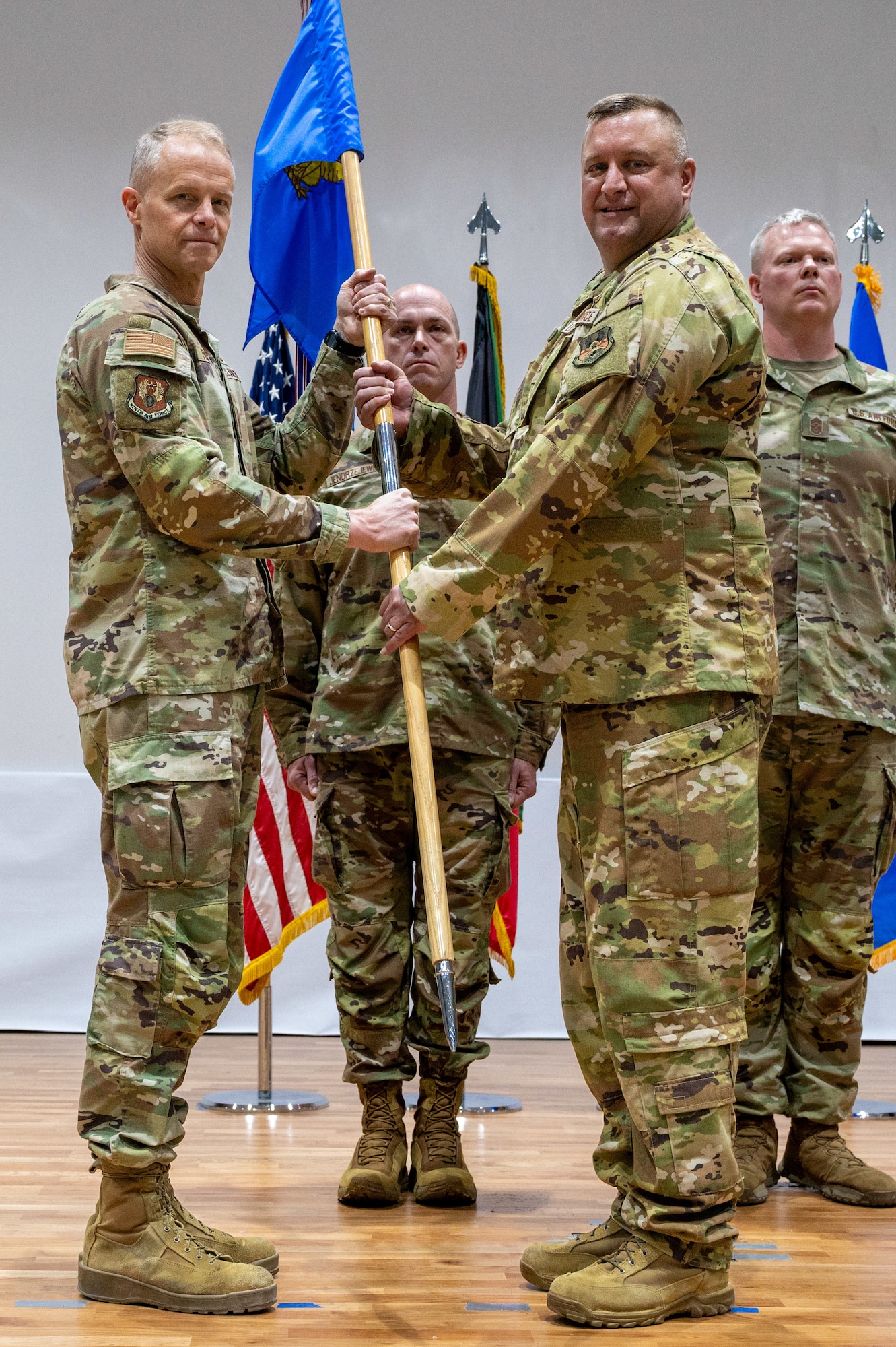 Lt. Gen. France is left of frame presenting the guidon to Col. Stouffer who is right of frame in honor of the latter's assumption of command