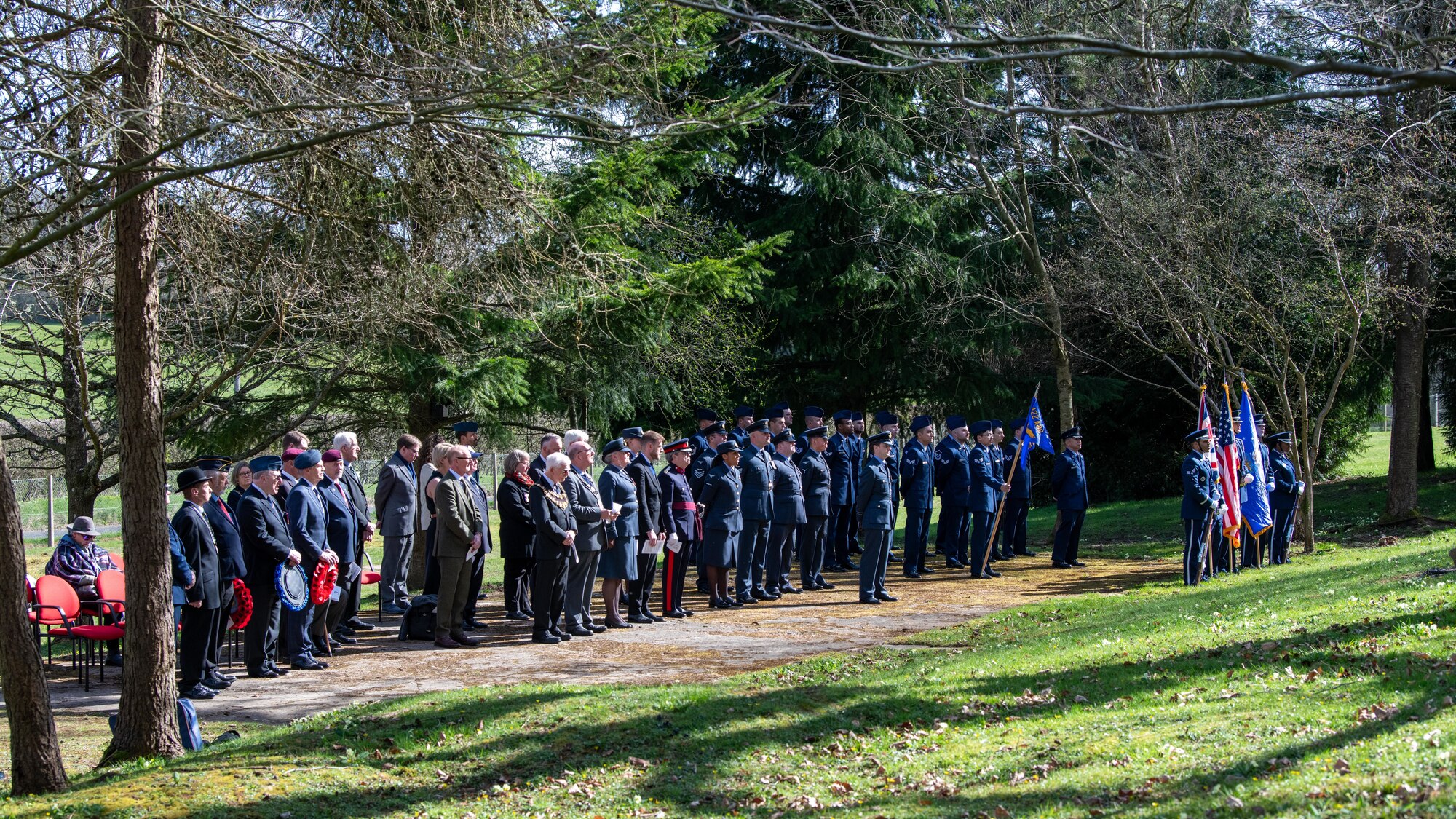 Members of the 501st Combat Support Wing and the local community stand during a memorial service