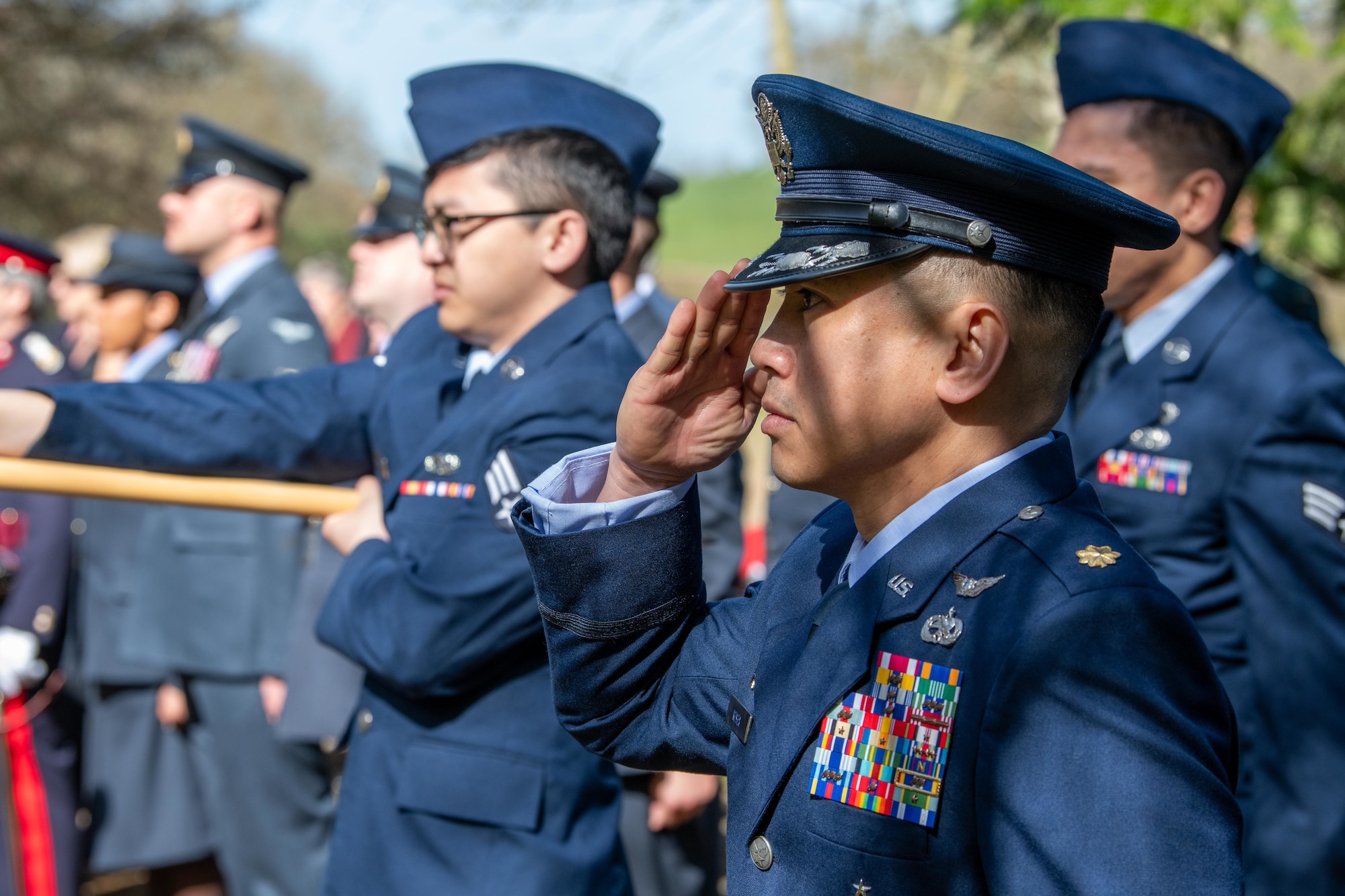 Squadron commander renders a salute during a memorial service
