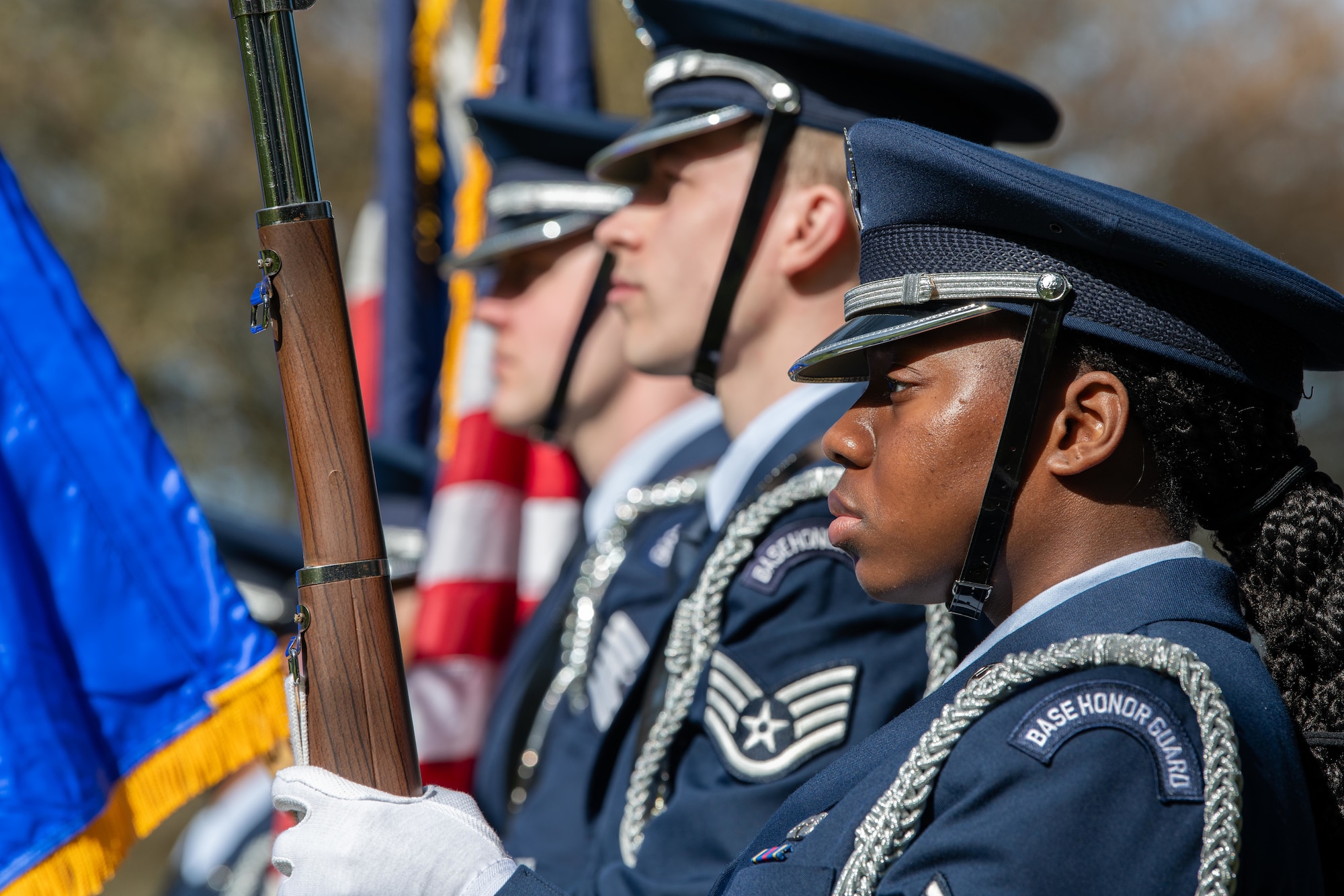 Airmen from the 422nd Air Base Group honor guard present the colors during a memorial service