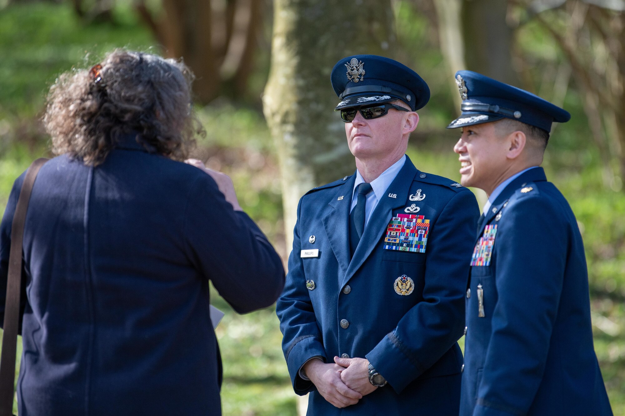 Commanders speaks with a community member before a memorial service