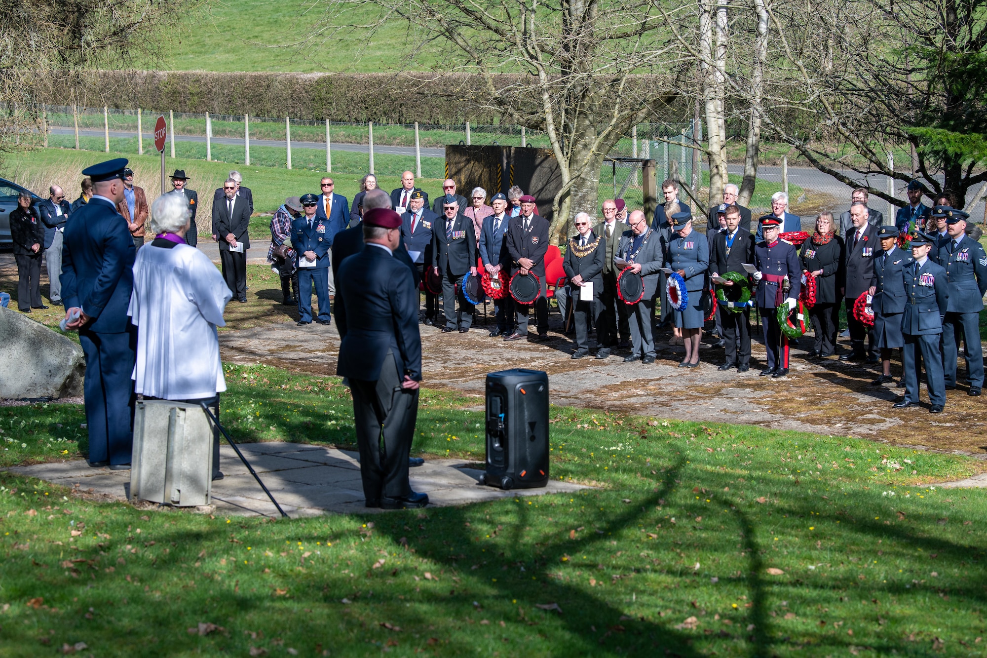 Members of the 501st Combat Support Wing and the local community stand during a memorial service