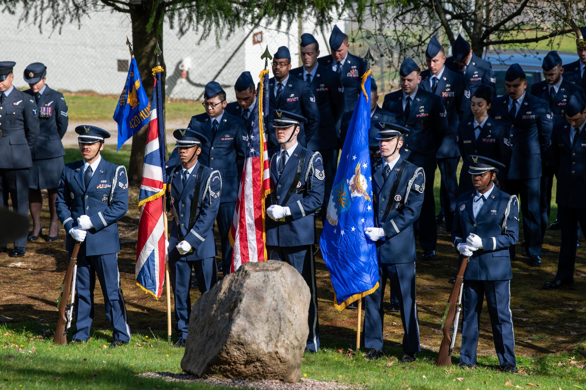 Members of the 501st Combat Support Wing and the local community stand during a memorial service