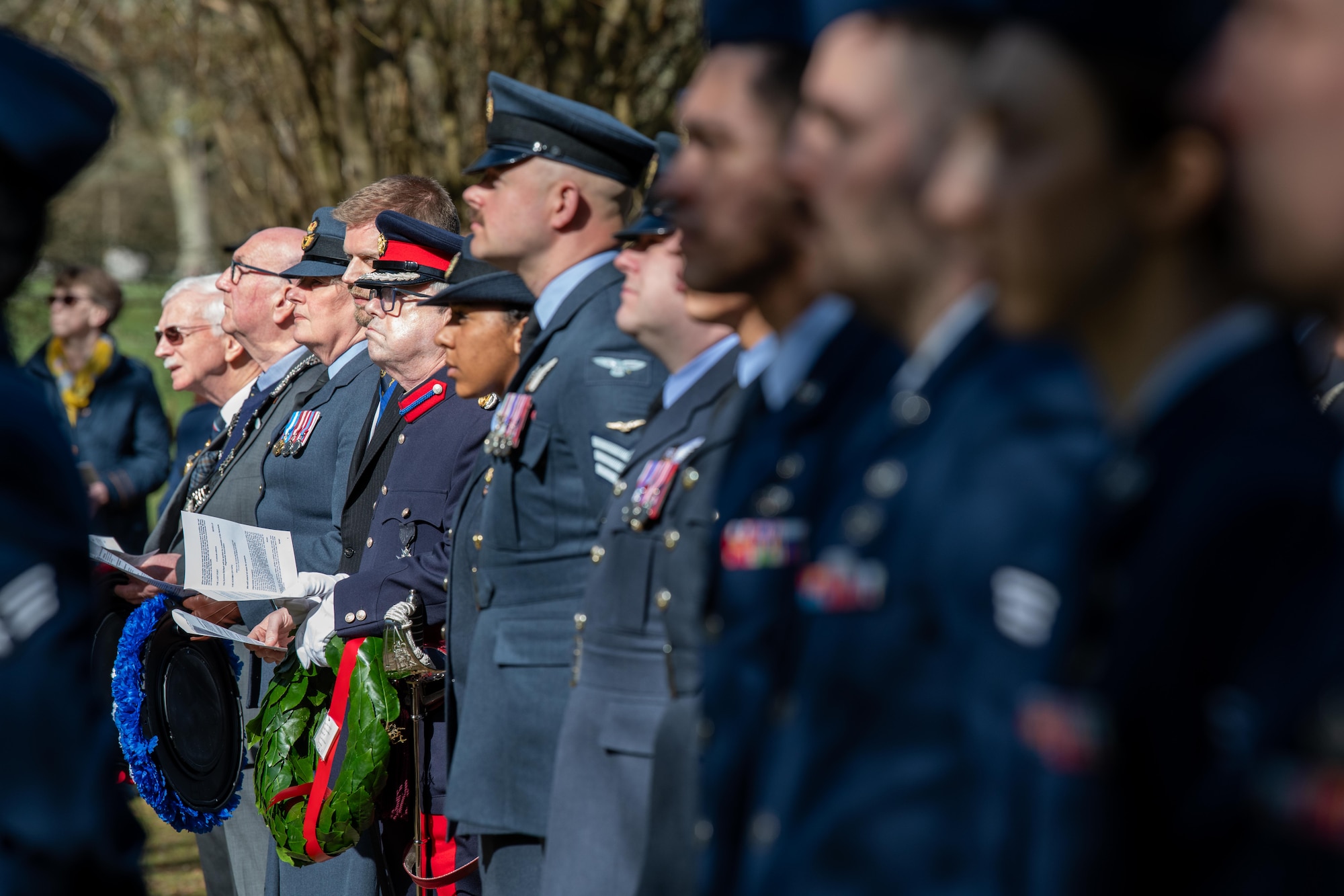 Members of the 501st Combat Support Wing and the local community stand during a memorial service