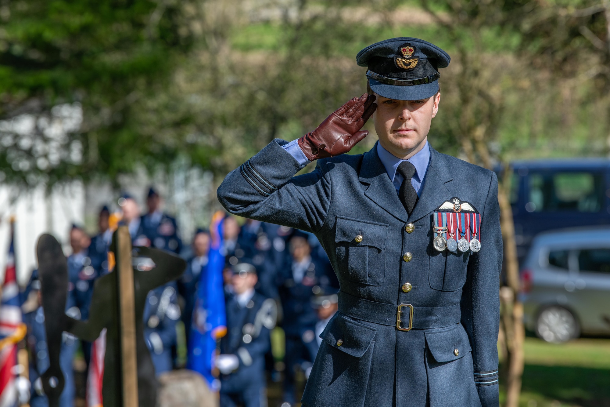 Royal Air Force pilot renders a salute during a memorial service