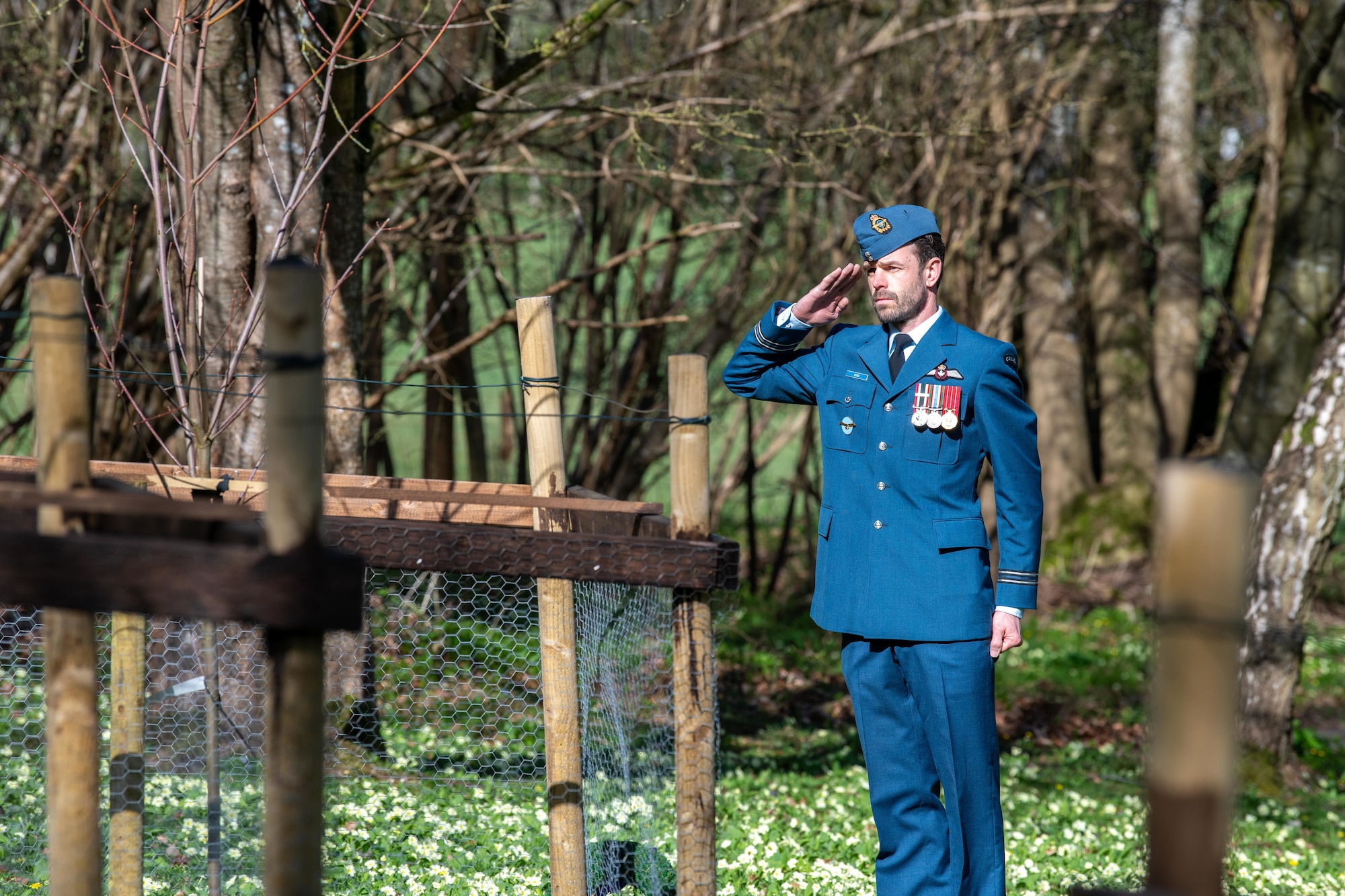 Royal Canadian Air Force Capt. renders a salute during a memorial service