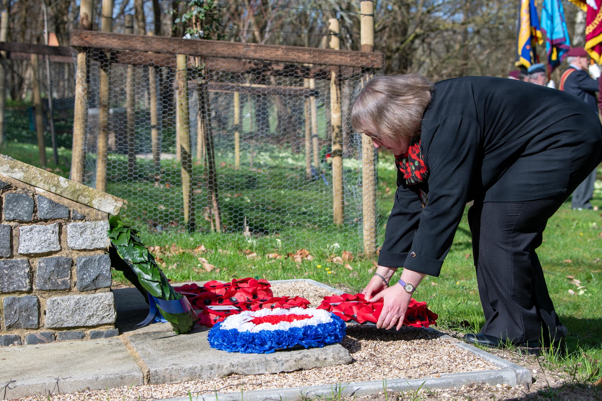 Family member lays a wreath during a memorial service