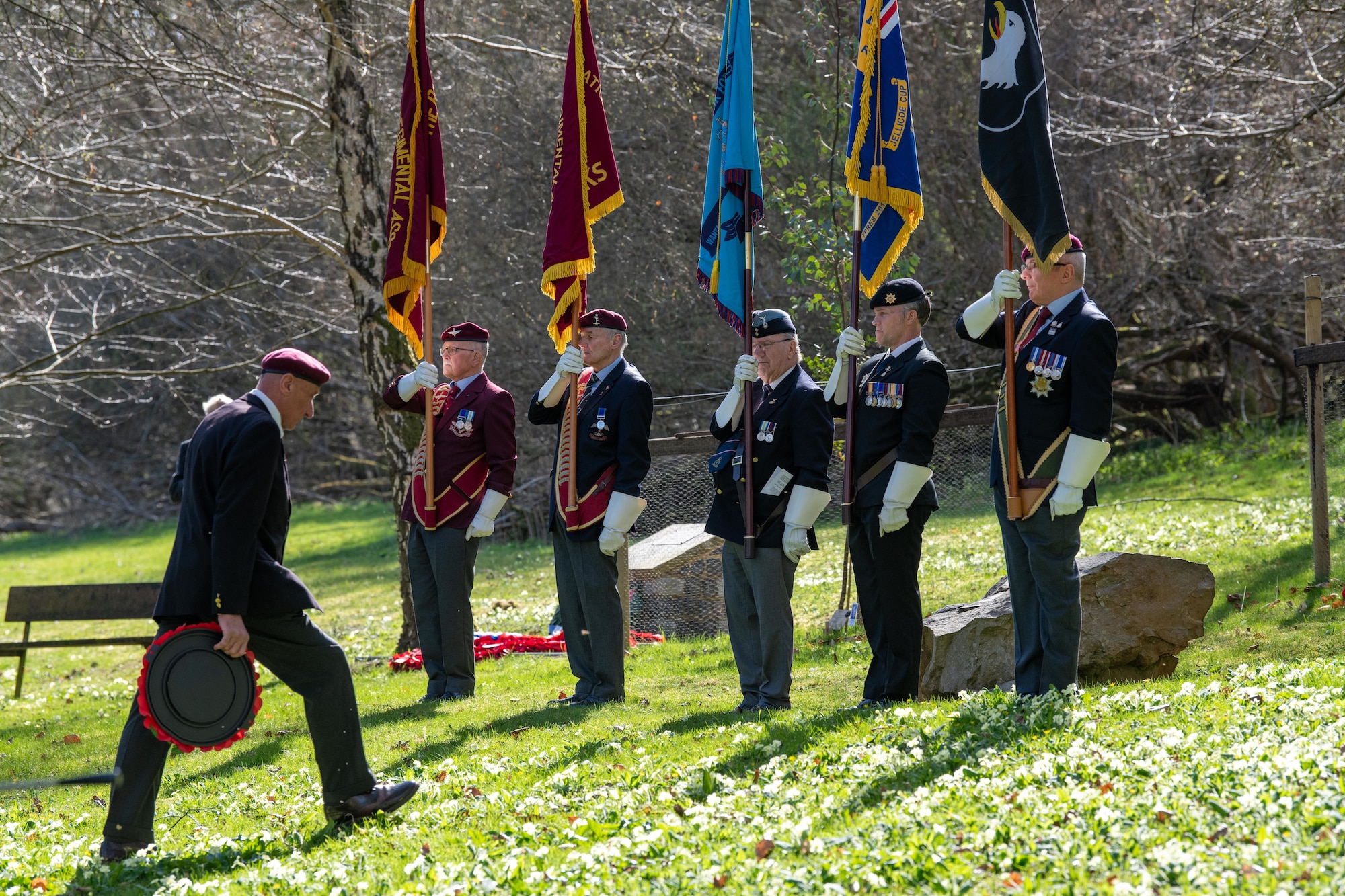 A community member prepares to lay a wreath during a memorial service