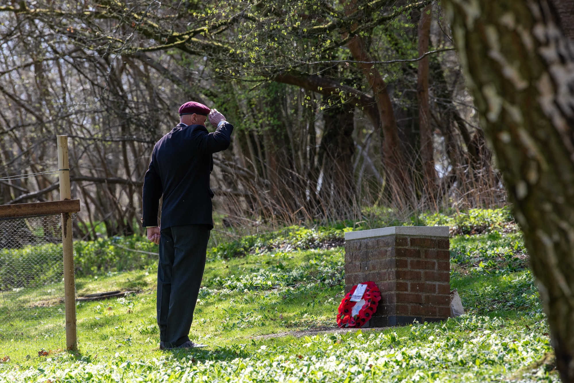 A community member renders a salute during a memorial service