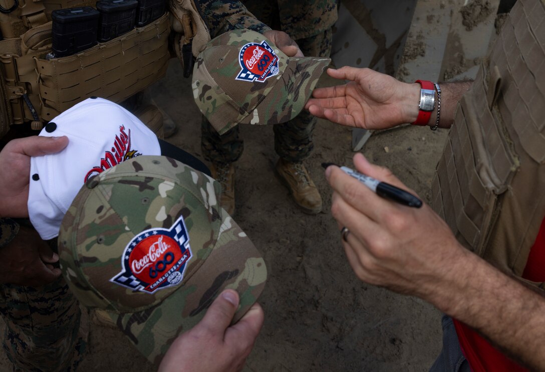 Joey Logano, a NASCAR Cup Series Champion as driver No. 22 Team Penske Ford, signs autographs for U.S. Marines with 2d Combat Engineer Battalion, 2d Marine Division on Marine Corps Base Camp Lejeune, North Carolina, April 8, 2024. The purpose of this visit is to provide Charlotte Motor Speedway senior leaders, NASCAR Drivers, and crew the opportunity to meet with Marines and get a first-hand experience of what it takes to join, train and become Marines through interactive activations and demonstrations. (U.S. Marine Corps photo by Lance Cpl. Alexandria Serrano)