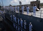 Sailors assigned to the submarine tender USS Emory S. Land (AS 39) man the rails as the ship returns to its homeport in Apra Harbor, Guam, after its 11-month, 17-port deployment, Apr. 9, 2025.