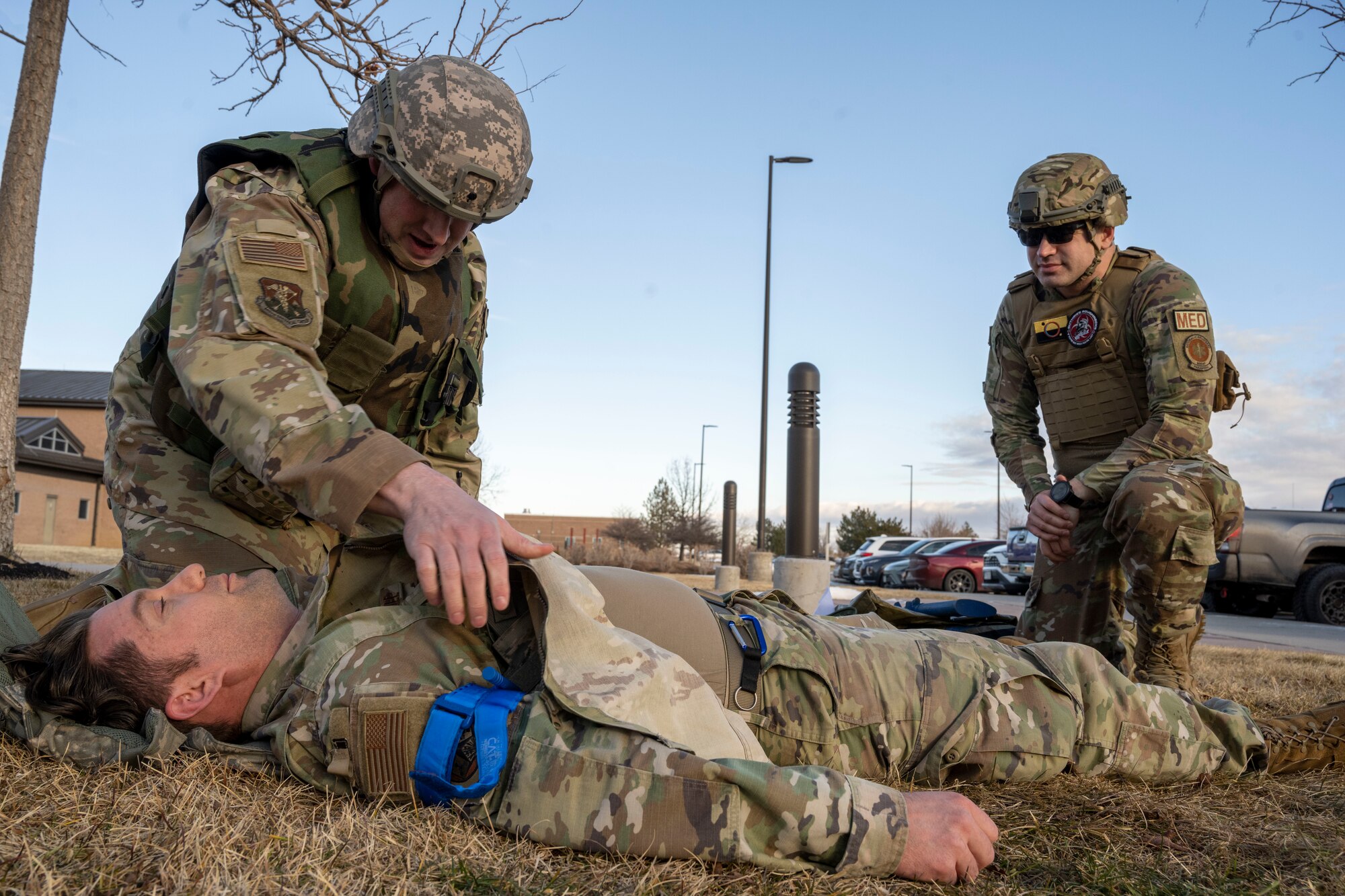U.S. Air Force Tech. Sgt. Charles Guthrie (right) instructs U.S. Air Force Staff Sgt. William Shimel as he provides simulated care to U.S. Air Force Staff Sgt. Spencer Parmelee during Total Combat Casualty Care training at Buckley Space Force Base, Aurora, Colorado, Jan. 29, 2025. Both airmen are 140th Medical Group aerospace medical technicians. Airmen from the 140th Medical Group, Colorado Air National Guard received training as part of a week-long series TCCC, Tier 3 intended for medical personnel. (U.S. Air National Guard photo by Tech. Sgt. Chance Johnson)