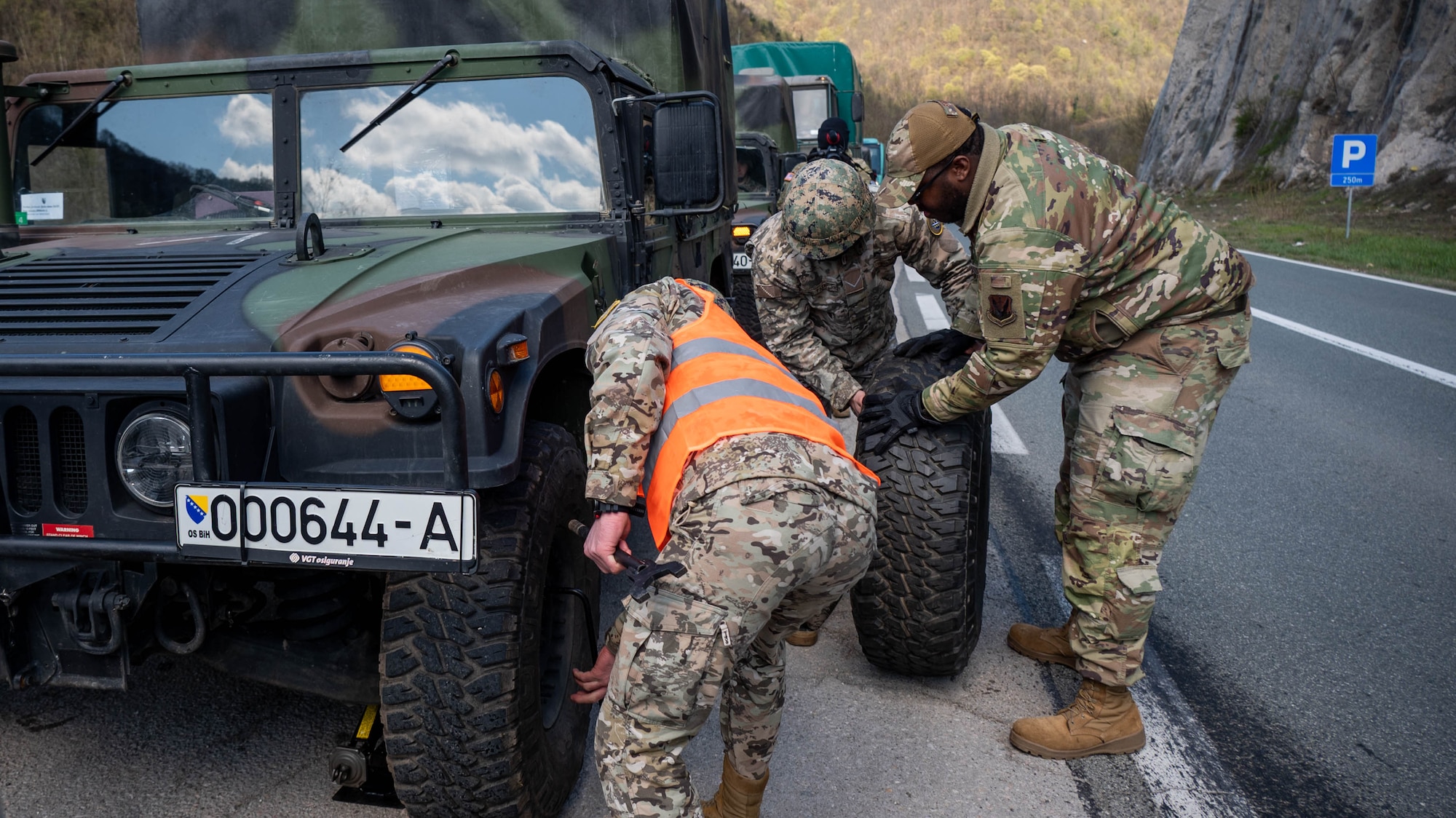 Maryland Air National Guard Staff Sgt. DeVaughn Brown, material management specialist for the 175th Logistics Operations Squadron, helps a member of the Armed Forces of Bosnia and Herzegovina roll a Humvee tire after a simulated flat inject during a convoy operation from Zenica to Visoko, in Lašva, Bosnia and Herzegovina, April 7, 2025.